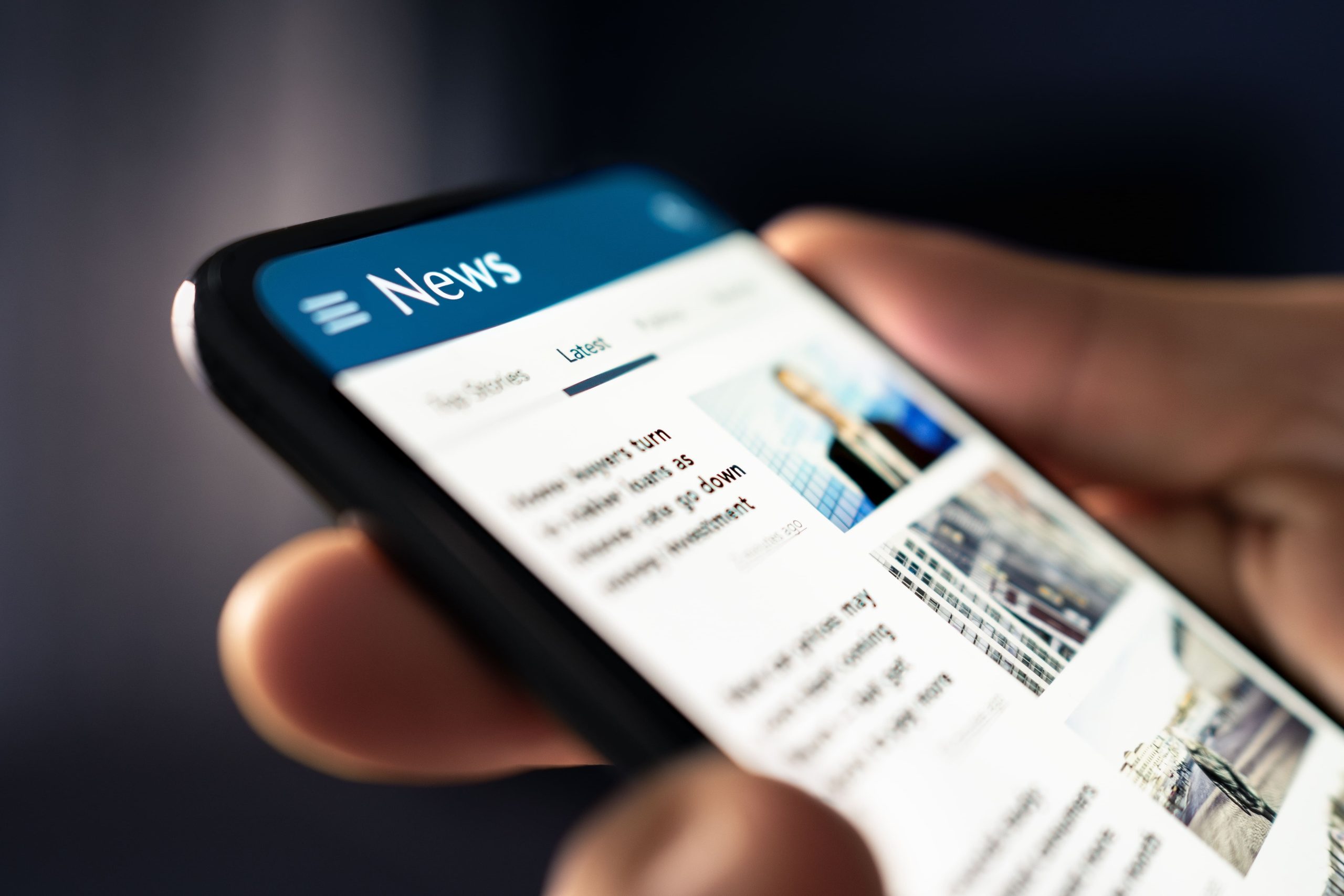 mobile phone with the day's news as the background