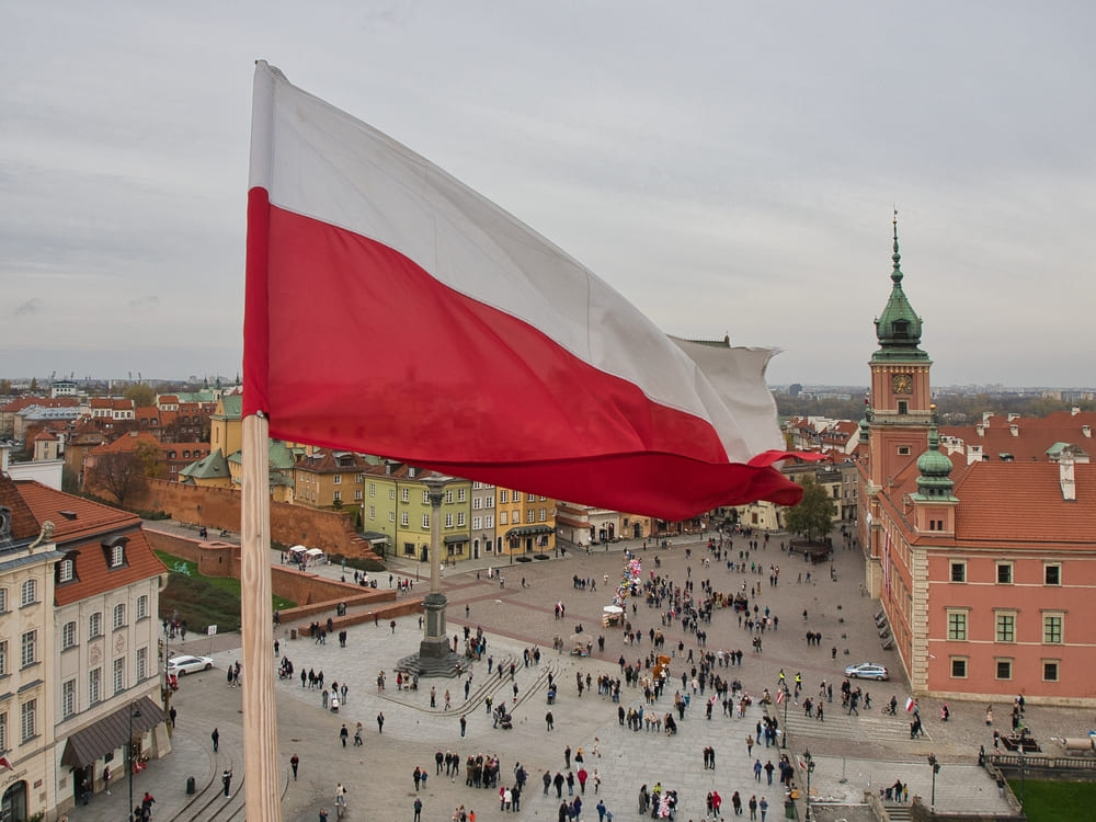 Polish flag and Warsaw in the background