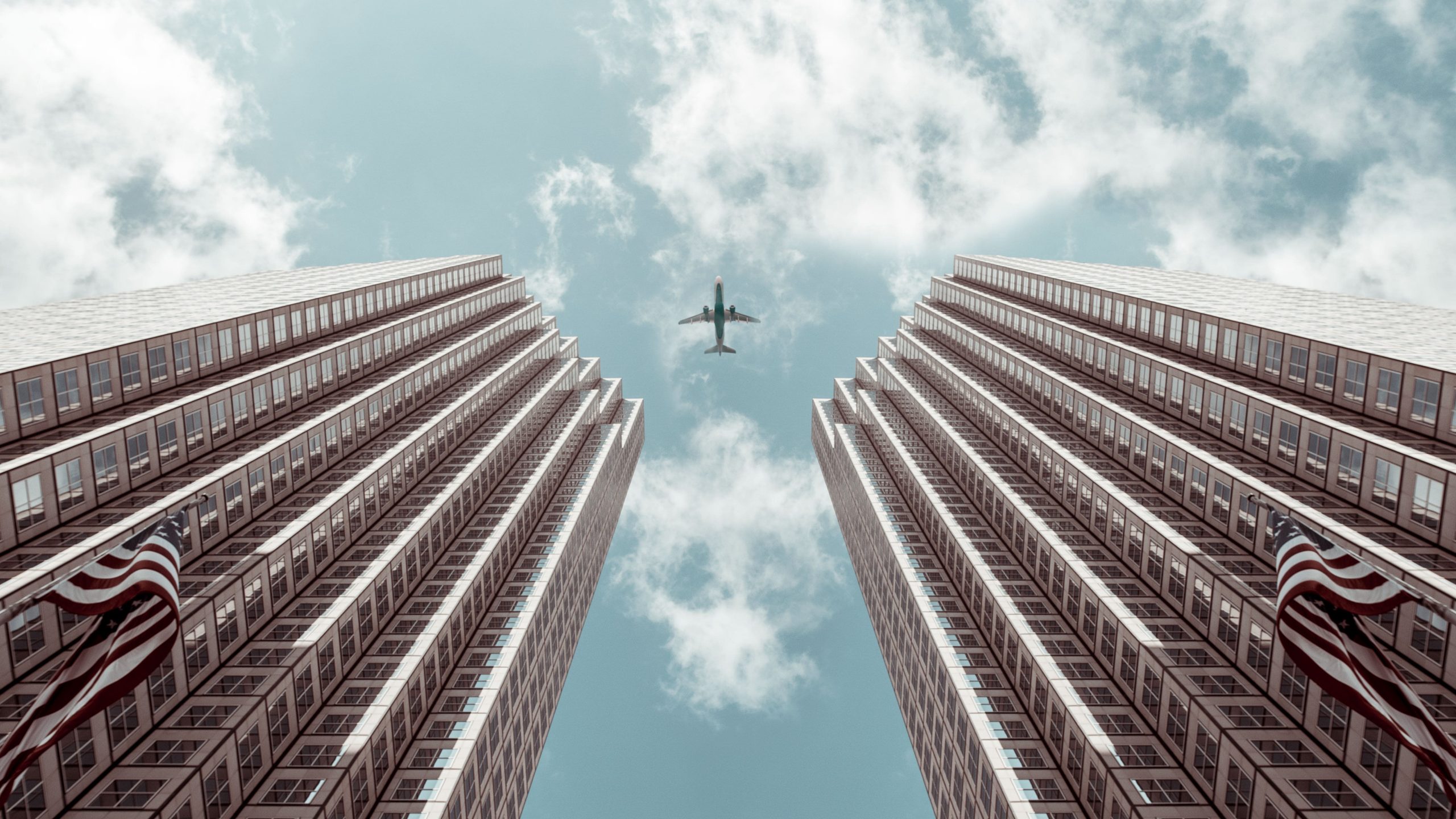 Airplane flying between two American skyscrapers